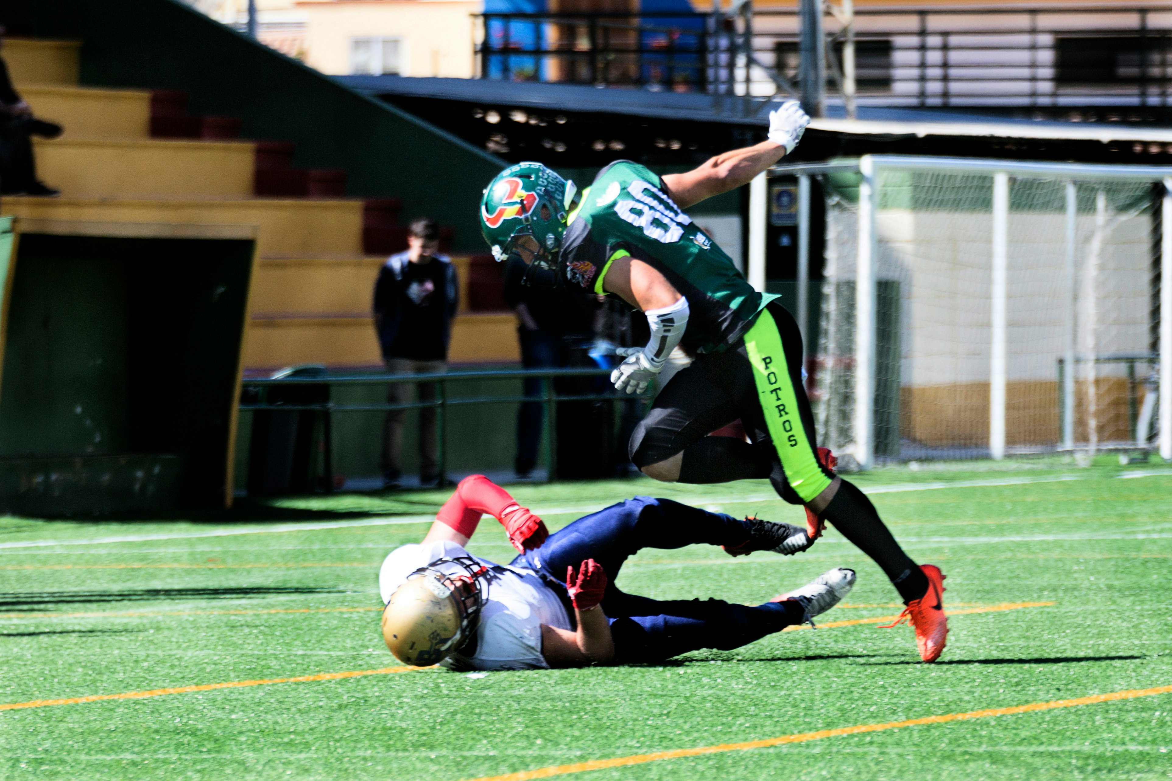 two men playing football during daytime